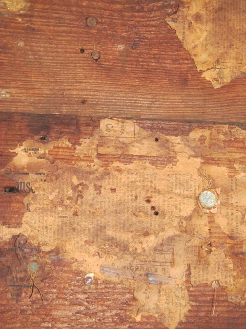 old newspaper on rough sawn boards