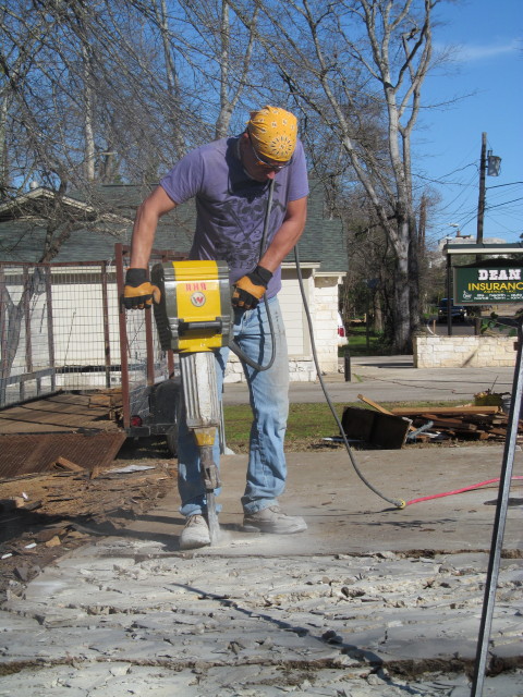 jackhammering the concrete 