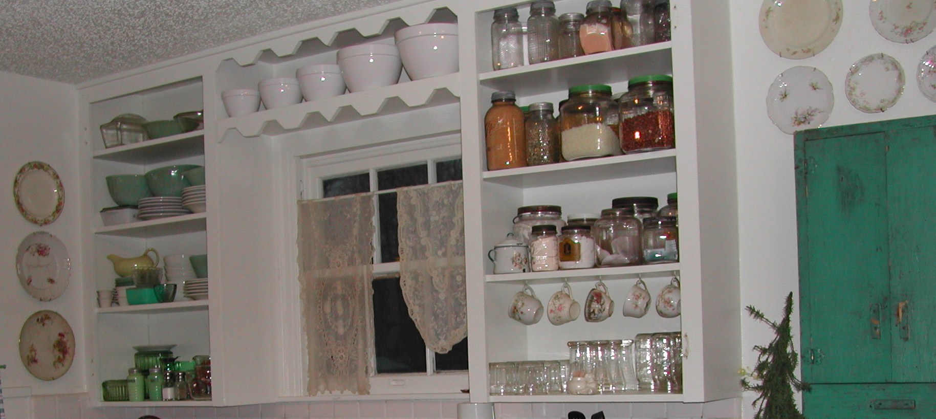 decorative jars, teacups, and plates in old kitchen