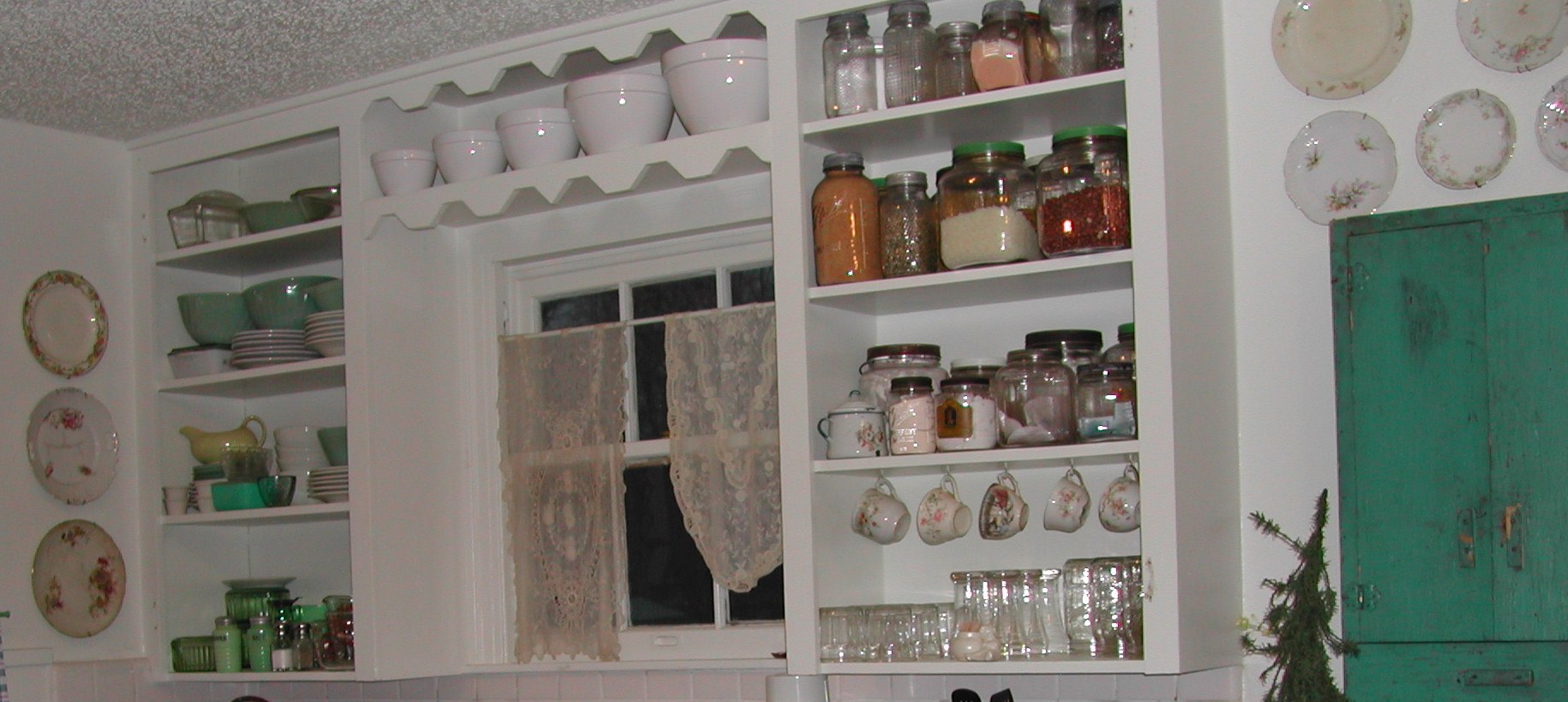 decorative jars, teacups, and plates in old kitchen
