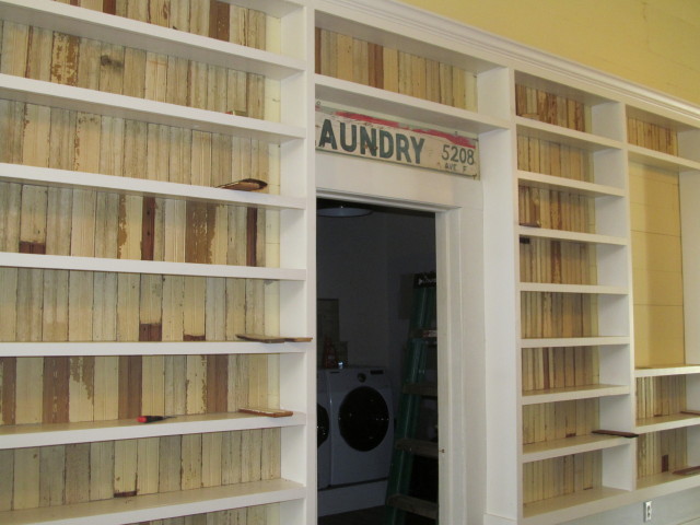 our bookshelves flank the entrance to the laundry room
