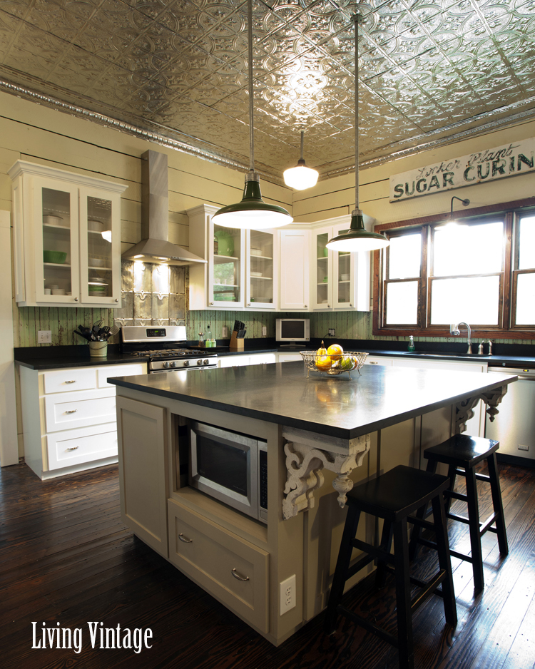 a vintage kitchen renovation - check out the tin ceiling, corbels, old signs, pantry screen door, and unique backsplashes!