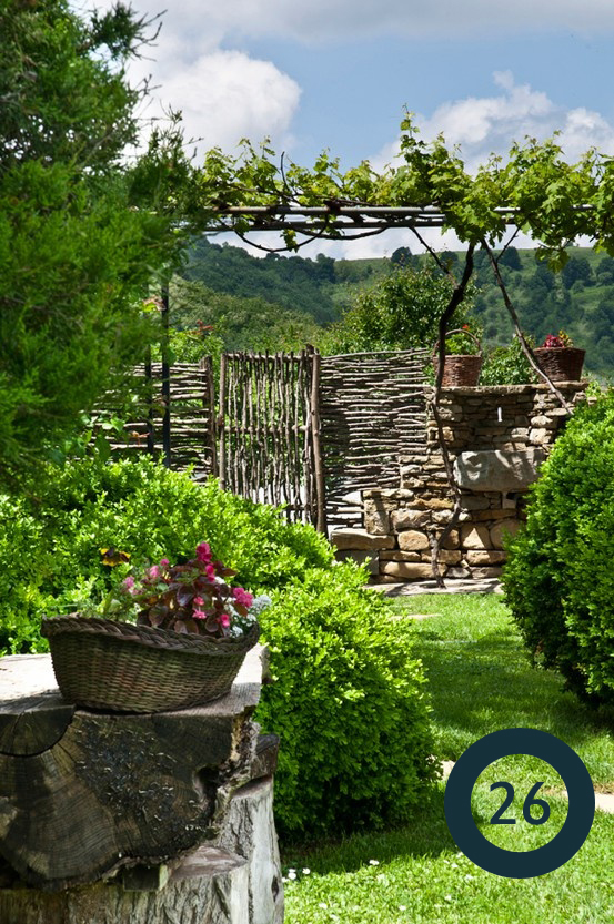 a gorgeous natural fence built with tree limbs