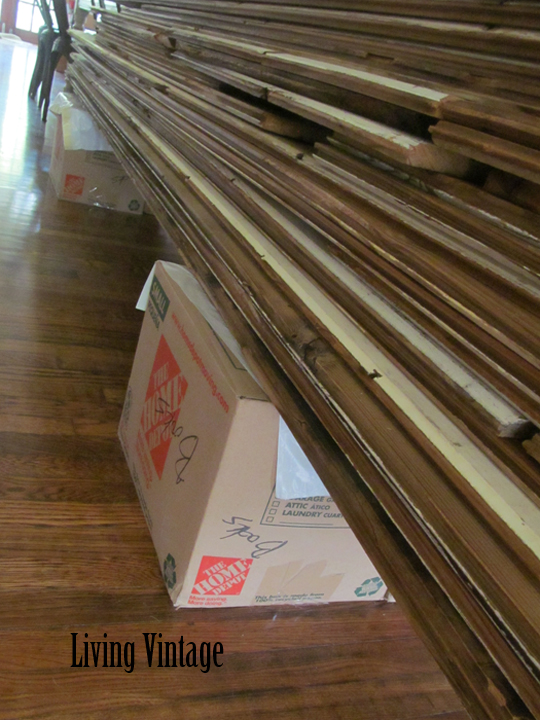 stack of groove board covering up boxes of books