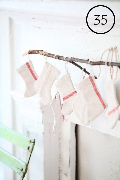 use a small branch to hang stockings above a mantel
