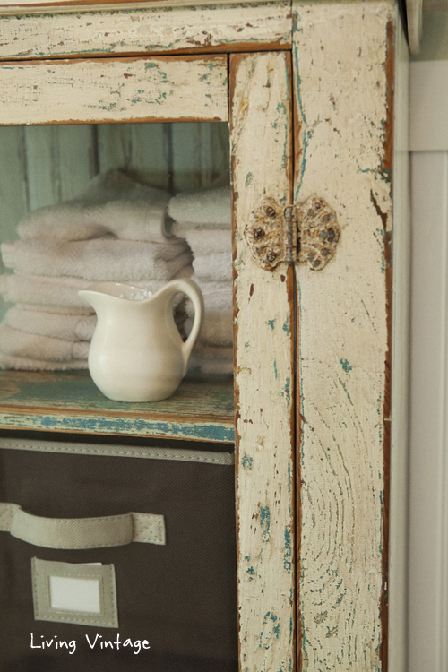 detail view of bathroom storage cabinet -- i keep qtips in the mini pitcher - Living Vintage