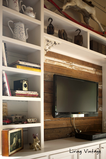 old corbels decorate the entertainment center - click on over to see the full reveal!  Living Vintage