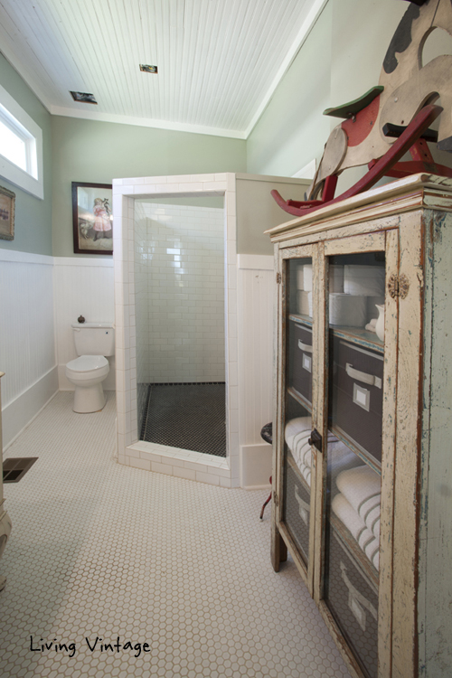 An old cabinet is used to store linens and a large walk-in shower - Living Vintage