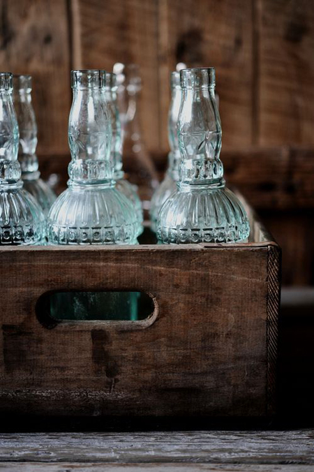fragile bottles displayed in an old crate - Friday Favorites - Living Vintage