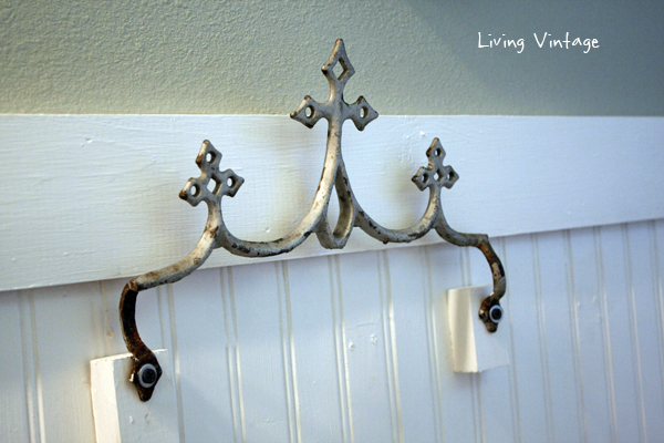 A reclaimed metal roof ornament, now a towel hook