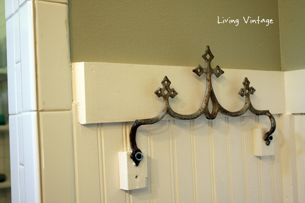 A reclaimed metal roof ornament, now a towel hook
