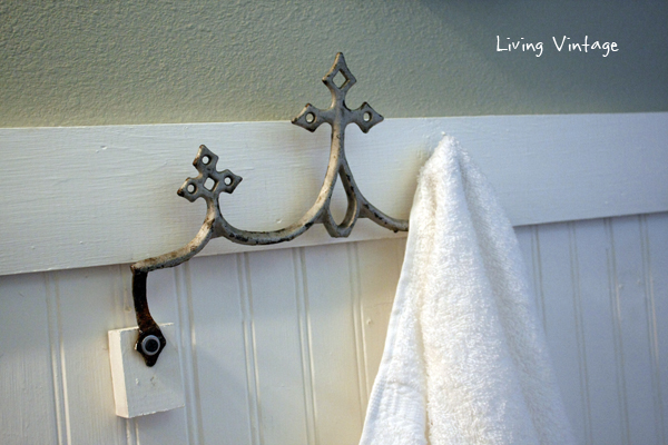 A reclaimed metal roof ornament, now a towel hook