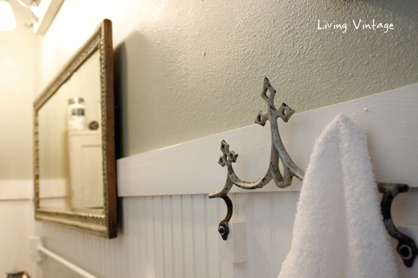 A reclaimed metal roof ornament, now a towel hook