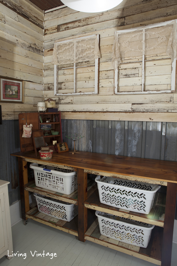 reclaimed siding and tin on the walls and reclaimed wood for the laundry sorter!