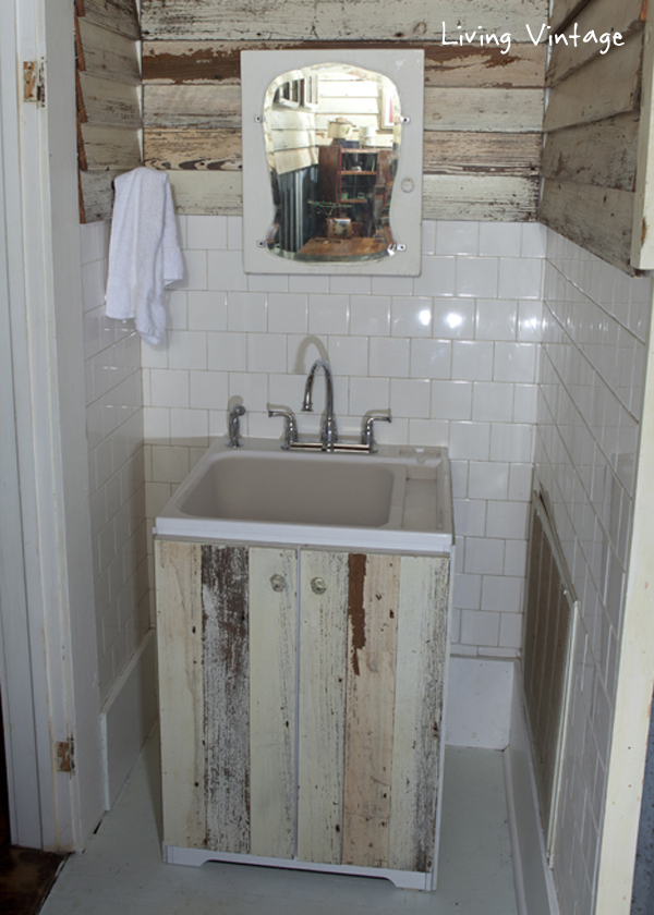 a cheap laundry sink clad in reclaimed siding