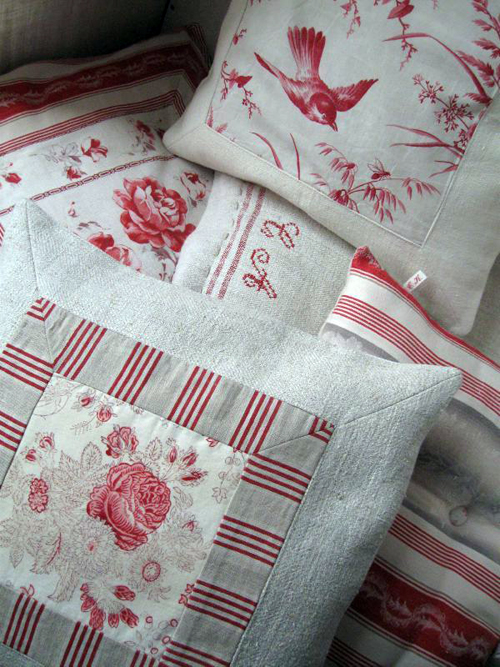 pillows made with an assortment of antique linen pieces