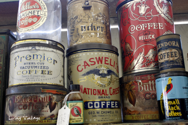 a collection of antique coffee tins and jars in Two Sisters Antiques booth