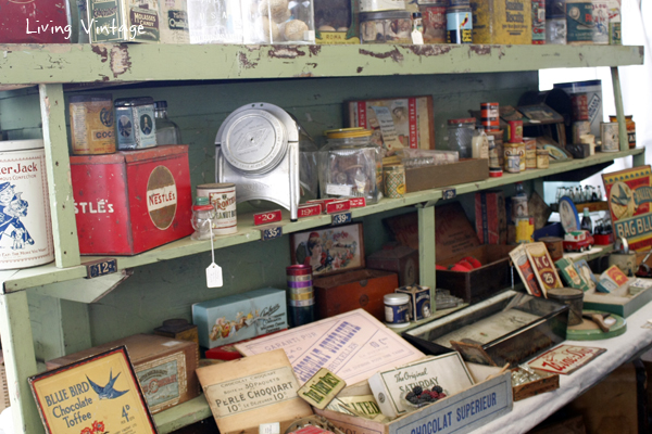 a fun green shelf and a display of vintage advertising and other smalls