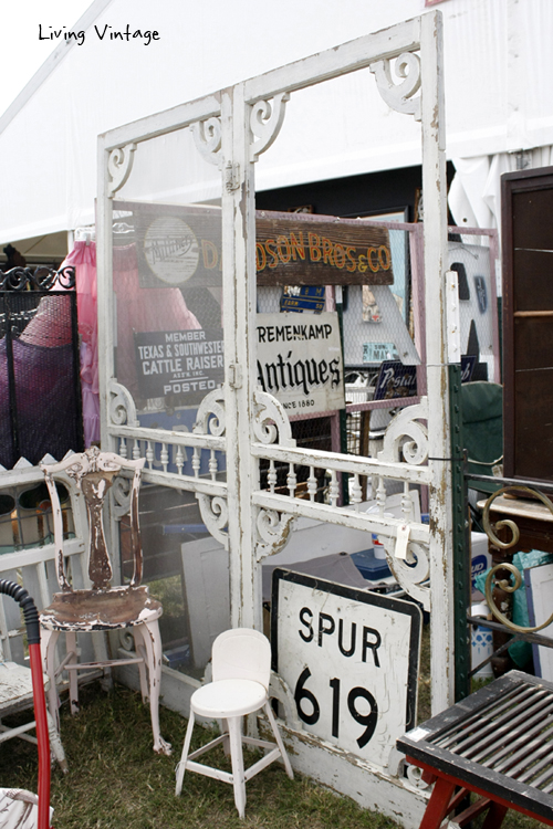 a pair of beautiful screen doors in front of a display of old signs