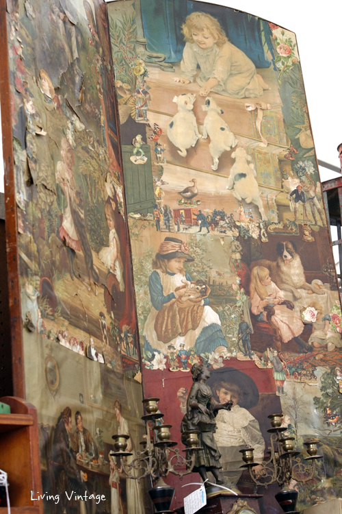 an old screen decoupaged with vintage illustrations of children and dogs