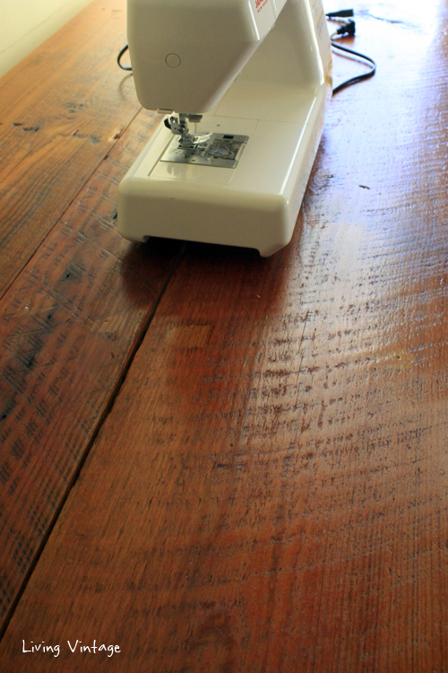 a gorgeous sewing table made using reclaimed table legs, wood, and trim