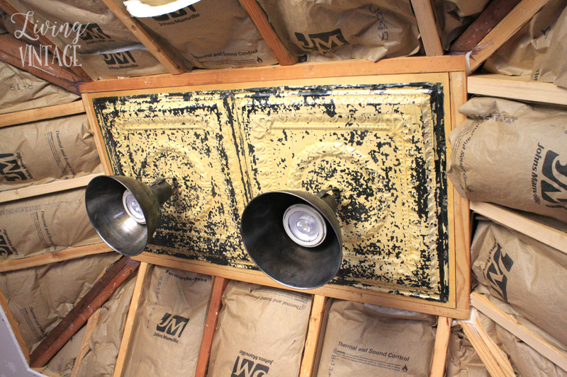 reclaimed ceiling tin and light fixtures repurposed to decorate a renovated kitchen