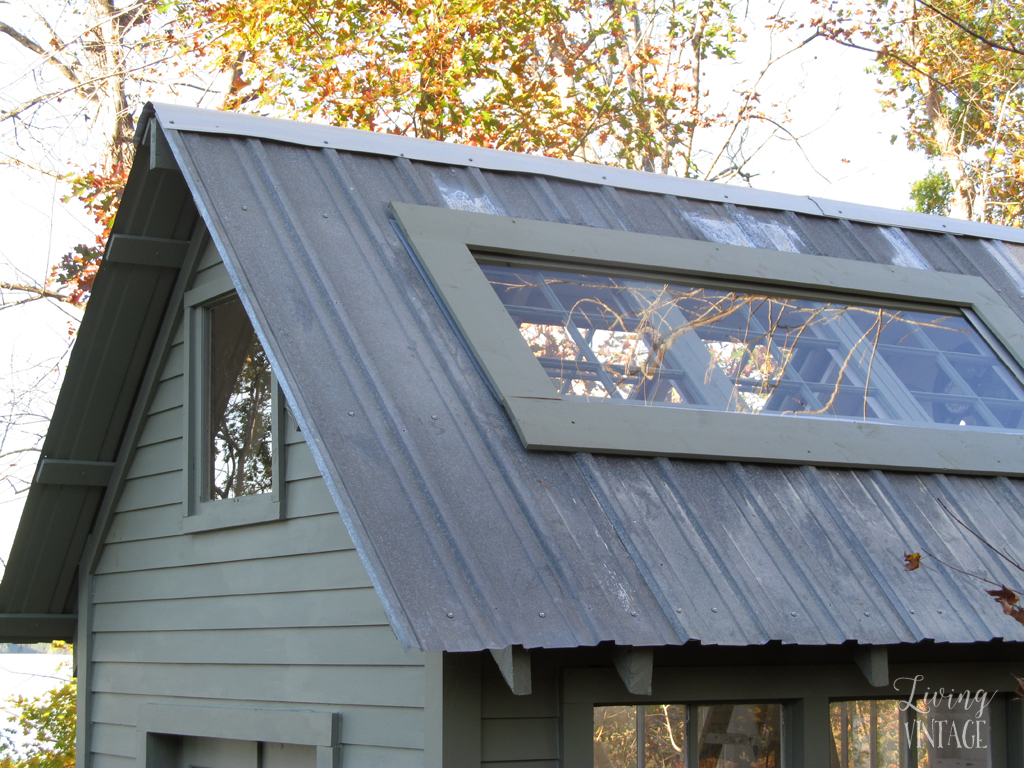 reclaimed windows and plexiglass on the roof of this cute little greenhouse - see more photos @ Living Vintage