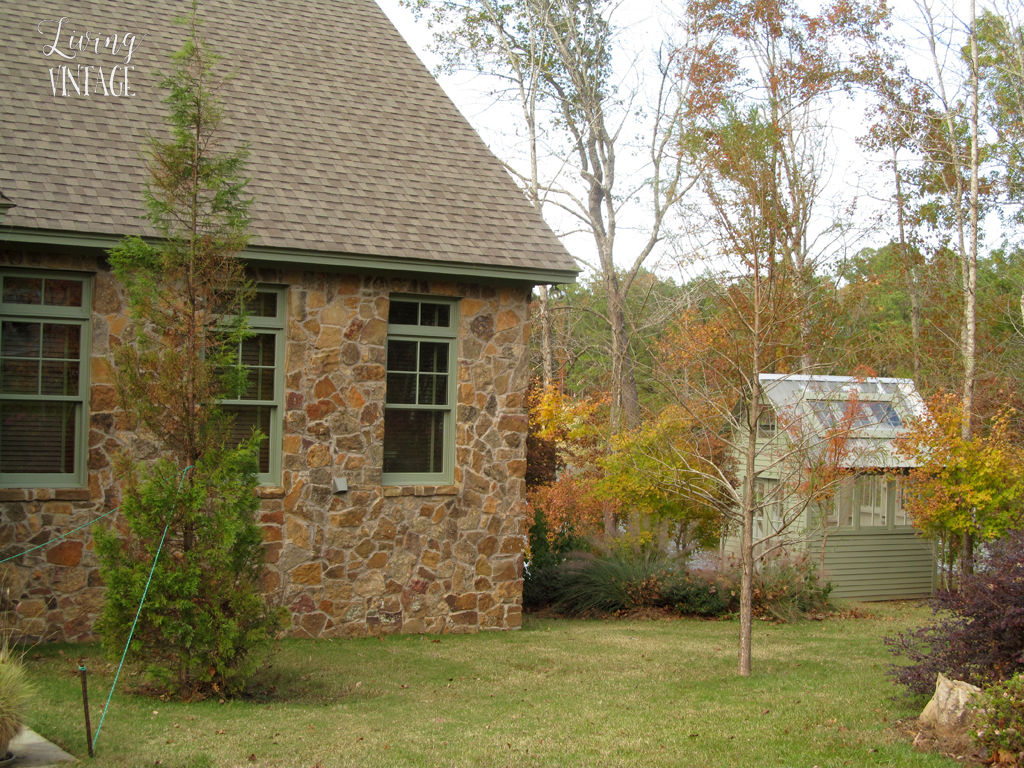 A really cute little greenhouse that matches the trim on the owners' home- see more photos @ Living Vintage