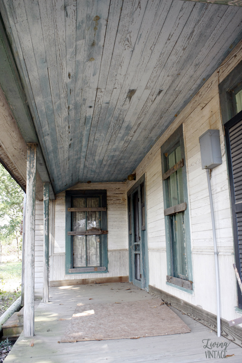 an old porch with a gorgeous blue ceiling