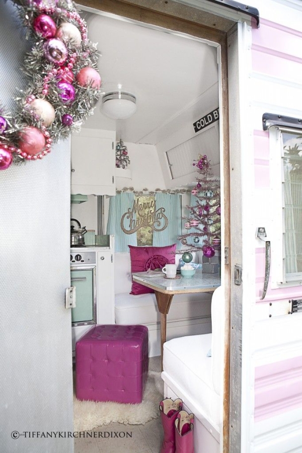 a vintage trailer decorated for the holidays