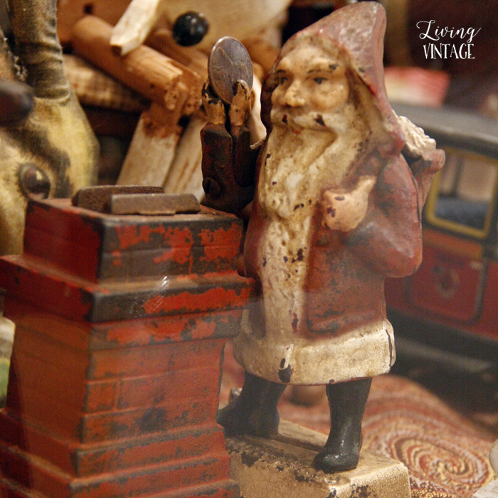 Santa makes a deposit in a cast iron toy bank